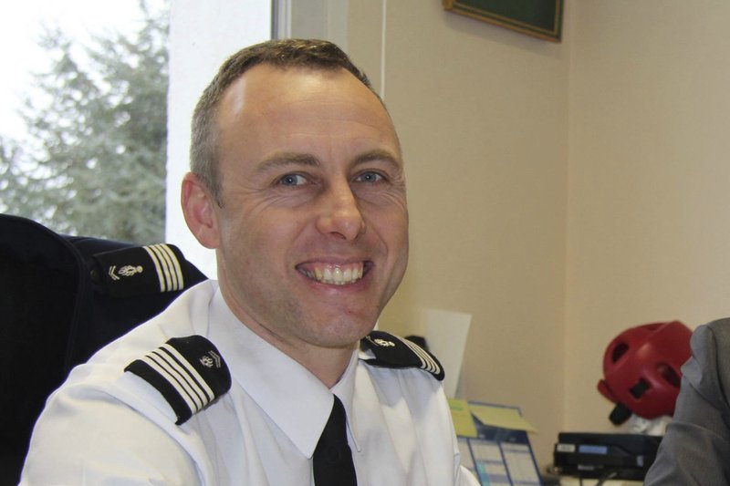 In this image dated March 2013 and provided by regional newspaper Ouest France, Arnaud Beltrame poses for a photo in Avranches, western France. The officer who offered to be swapped for a female hostage was identified as Col. Arnaud Beltrame. He managed to surreptitiously leave his phone on so that police outside could hear what was going on inside the supermarket — and crucially, decide when to storm it. (Ouest France via AP)