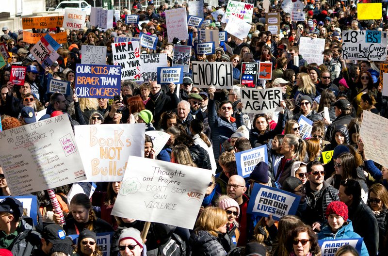 Crowds of people hold signs on Pennsylvania Avenue at the "March for Our Lives" rally in support of gun control Saturday, March 24, 2018, in Washington. 