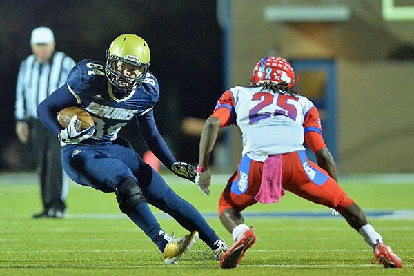 Pulaski Academy tight end Hudson Henry (left) looks to avoid McClellan defender Tyrse Lair (25) during a game Friday, Oct. 27, 2017, in Little Rock. 
