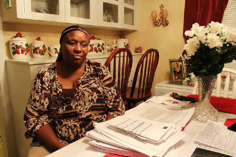 Sylvia Howard sits at her dining room table in east Crossett last week. “If they paid me, I’d get out of here tomorrow,” Howard said, alluding to past buyouts by Georgia-Pacific. 