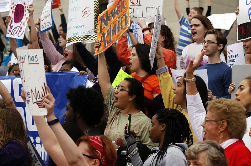 High school students and other protesters join Saturday’s march at the state Capitol in Little Rock.  