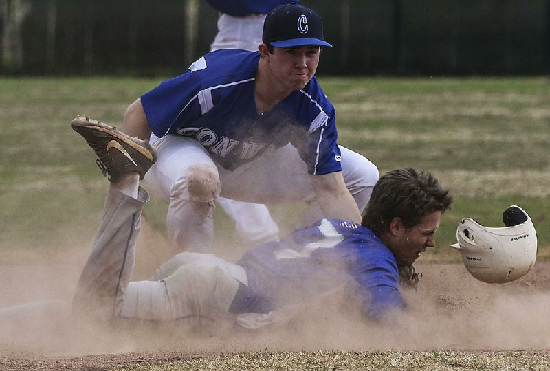 Conway’s Matthew Lloyd (top) tags out Bryant’s Logan Chambers at second base after getting caught in a rundown Friday during the Wampus Cats’ 6-5 victory over the Hornets in the semifi nals of the Central Arkansas Invitational in Little Rock.