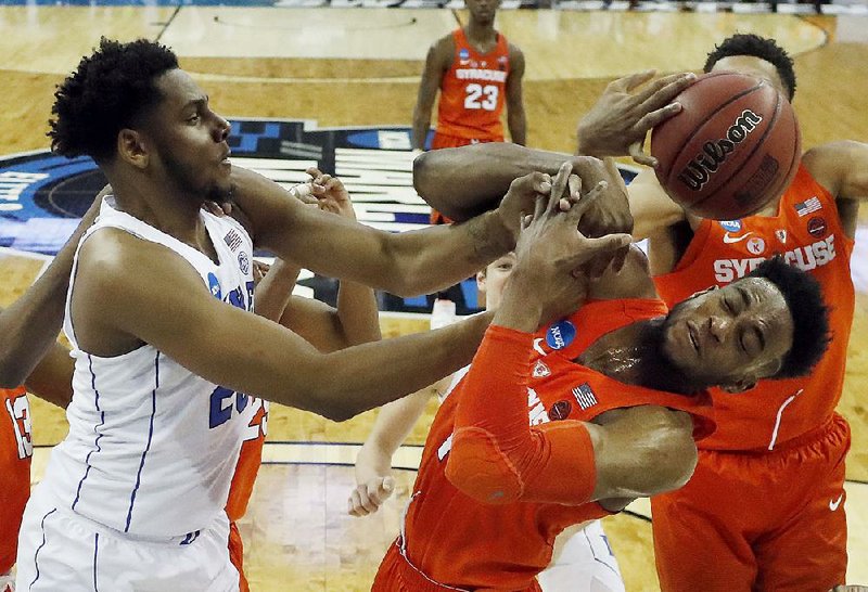 Syracuse’s Oshae Brissett (right) and Duke’s Marques Bolden battle for a rebound in the Blue Devils’ 69-65 victory over Syracuse. Duke will meet Kansas on Sunday in the regional final.