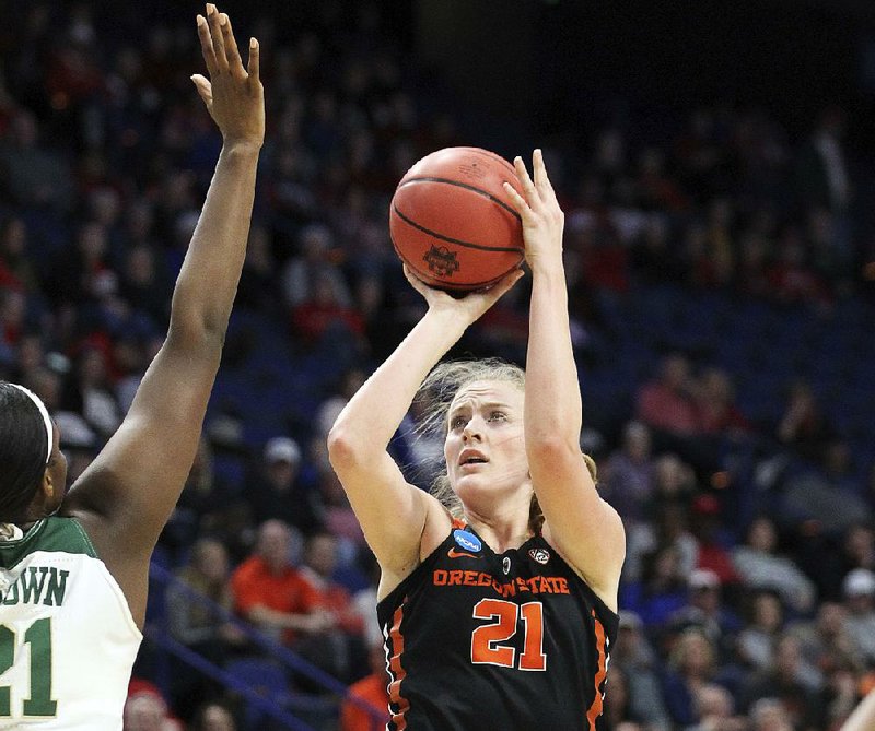 Oregon State’s Marie Gulich (right) shoots while under pressure from Baylor’s Kalani Brown during the fi rst half of Friday’s women’s NCAA Tournament regional semifi nal in Lexington, Ky. Gulich had 26 points and nine rebounds as the Beavers advanced with a 72-67 victory.