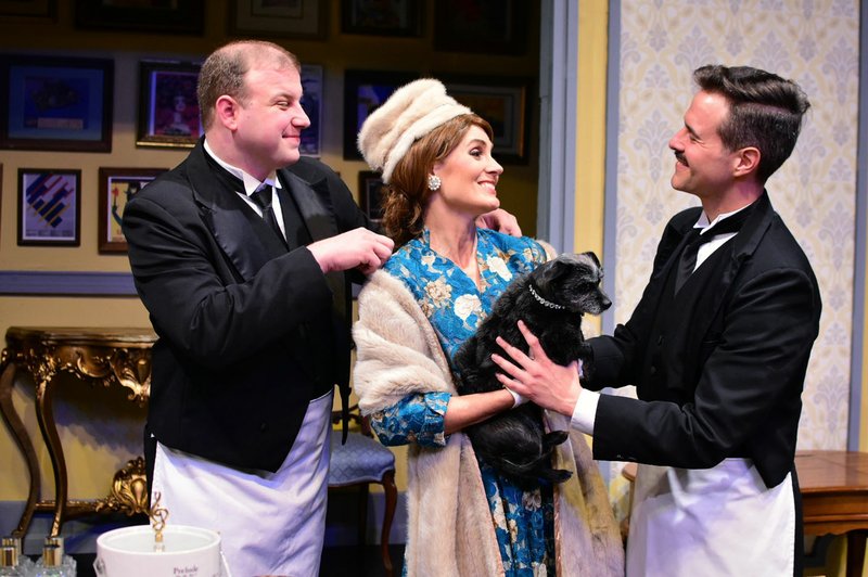 Photo courtesy Danielle Keller Butlers Eric (Travis Mitchell, left) and Bruce (Joseph K. Farmer, right) greet their boss as she returns to her opulent Manhattan penthouse after a faltering tour. Kate Taylor Williams plays La Diva in the Arkansas Public Theatre production of "Living On Love." Puccini is played by Minnie the dog.