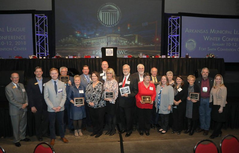 Courtesy photo Representatives from the 12 towns in Arkansas that were named a 2017 Volunteer Community of the Year were recognized at the Arkansas Municipal League's Winter Conference in Fort Smith in January. Siloam Springs was represented by Mayor John Mark Turner (second from right) and board of directors member Carol Smiley (third from right).