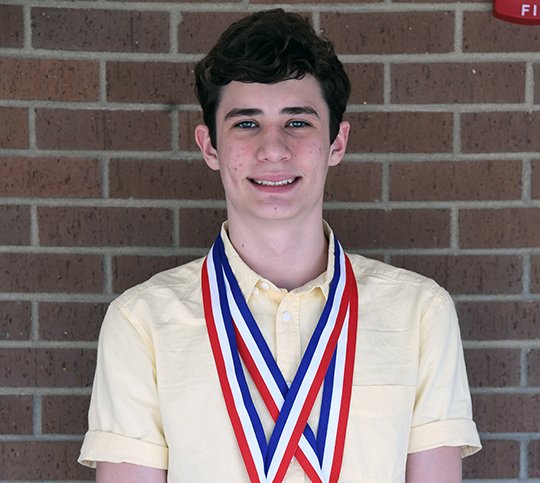 The Sentinel-Record/Grace Brown - Lakeside's Mason Vondenstein wears the medals he won for swimming inside Lakeside High School on Thursday, March 15, 2018. 