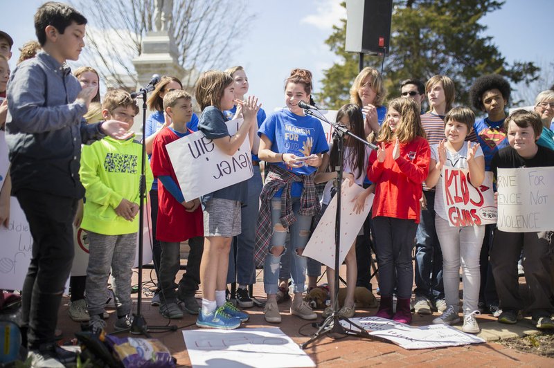 Children from area schools demonstrate during the March For Our Lives rally Saturday at the Bentonville Square in Bentonville. "March For Our Lives" is a march against gun violence. "[We're] just a group of kids who got together one day and wanted to make a change, " said Taylor Gibson, 16, a student at Bentonville West High School. She is one of nine students from area high schools including Bentonville West, Bentonville High, Gravette and Haas Hall who organized the rally. The rally is in solidarity with more than 800 protests around the world according to "March For Our Lives" organizers