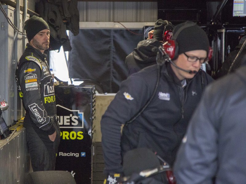 Jimmie Johnson watches his crew in the garage during practice for the NASCAR Cup Series auto race at Martinsville Speedway in Martinsville, Va., Saturday, March 24, 2018. (AP Photo/Matt Bell)