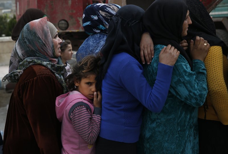 Syrians queue for food at a distribution centre in the northwestern city of Afrin, Syria, during a Turkish government-organised media tour into northern Syria, Saturday, March 24, 2018. Turkey and allied Syrian opposition fighters captured the city of Afrin on Sunday, March 18, nearly two months after the launch of an operation to clear the area of the main Syrian Kurdish militia known as the People's Protection Units or YPG. Turkey considers the YPG a terror group and an extension of Kurdish rebels waging an insurgency within its own borders.(AP Photo/Lefteris Pitarakis)