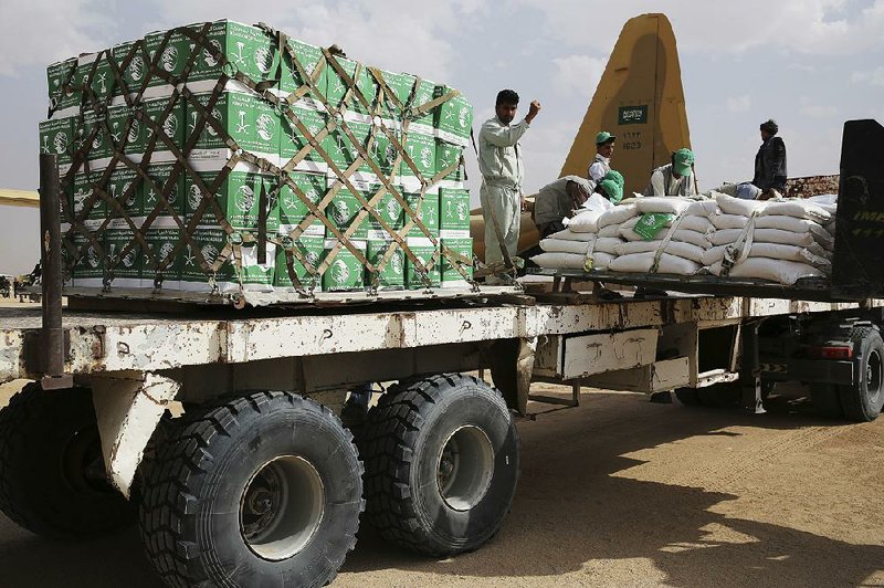 Relief workers in February unload aid in Marib, Yemen, that was carried into the country by the Saudi military.