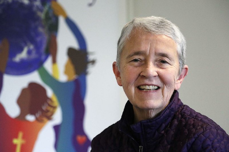 In this Thursday, March 22, 2018, photo, Sister Judy Byron, director and coordinator of the Northwest Coalition for Responsible Investment, poses for a photo in her office in Seattle. 