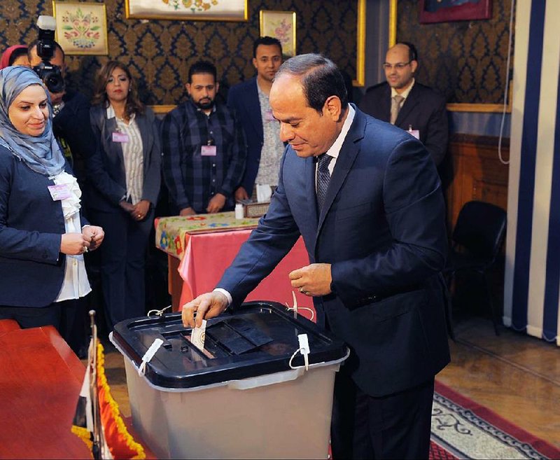 Egyptian President Abdel-Fattah el-Sissi, who is running for a second four-year term, votes in Cairo suburb on Monday.  