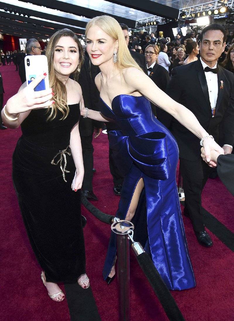 Actress Nicole Kidman (right) takes a selfie with fan at the Oscars earlier this month.  