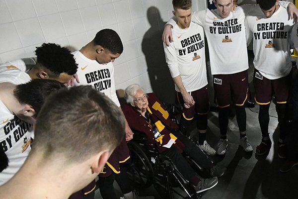 Loyola-Chicago chaplain Sister Jean Dolores Schmidt, leads the team in brayer before the first half of a regional final NCAA college basketball tournament game between Loyola-Chicago and Kansas State, Saturday, March 24, 2018, in Atlanta. (AP Photo/John Amis)

