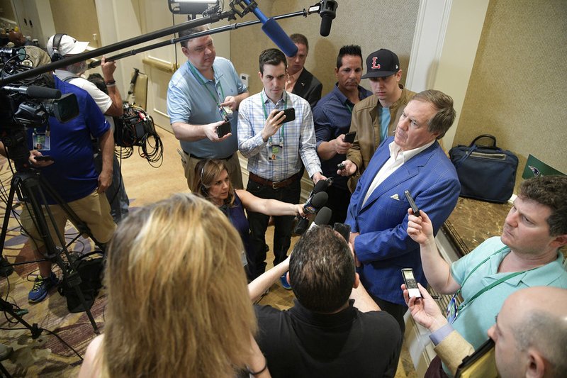 New England Patriots head football coach Bill Belichick, right, answers a question from a reporter at the coaches breakfast during the NFL owners meetings, Tuesday, March 27, 2018 in Orlando, Fla. (Phelan M. Ebenhack/AP Images for NFL)