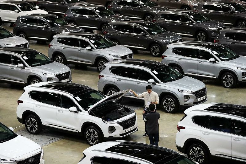 Hyundai Motor Co. Santa Fe sport utility vehicles are on display during a launch event for the updated vehicle in Goyang, South Korea, in February. Union autoworkers at Hyundai Motor Co. and Kia Motors Corp. in South Korea are protesting a revised trade agreement with the U.S.  