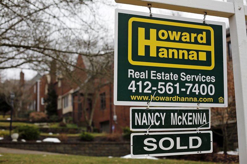 FILE- This Jan. 22, 2018, file photo shows a sold sign in front of a home in Mount Lebanon, Pa.  (AP Photo/Gene J. Puskar, File)