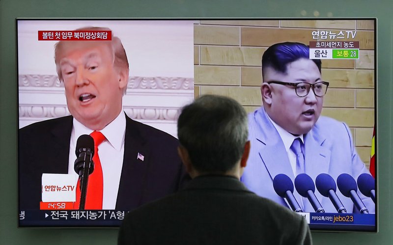 In this March 27, 2018 file photo, A man watches a TV screen showing file footages of U.S. President Donald Trump, left, and North Korean leader Kim Jong Un, right, during a news program at the Seoul Railway Station in Seoul, South Korea. Increased activity at a North Korean nuclear site has once again caught the attention of analysts and renewed concerns about the complexities of denuclearization talks as President Donald Trump prepares for a summit with Kim Jong Un. (AP Photo/Lee Jin-man, File)