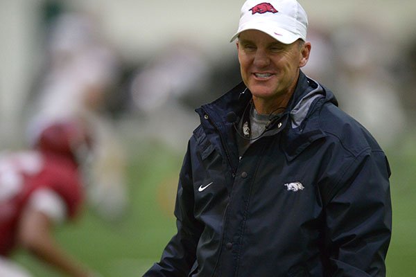Arkansas coach Chad Morris speaks with players Wednesday, March 28, 2018, during practice at the university's practice facility on campus in Fayetteville.