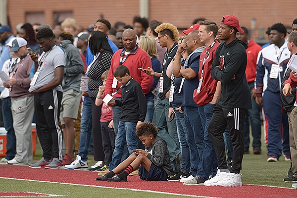 Visitors watch from the sideline during Arkansas' spring scrimmage on Saturday, March 10, 2018, in Fayetteville. 