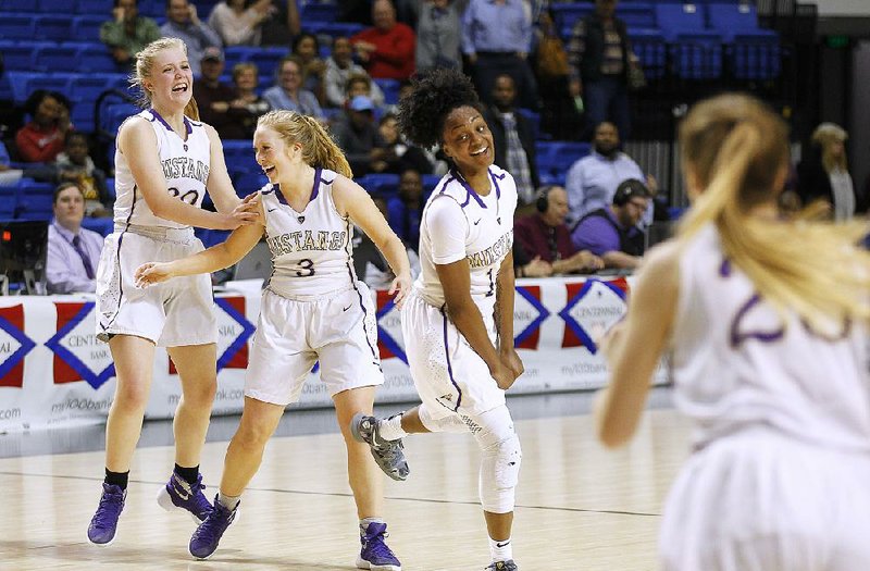 Central Arkansas Christian’s Alexa Mashburn (30),  Kelson Miller (3) and Christyn Williams (13) celebrate as the clock expires in the Mustangs' 58-57 win over Riverview in the Class 4A girls state championship game on Friday, March 9, 2018, at Bank of the Ozarks Arena in Hot Springs. 