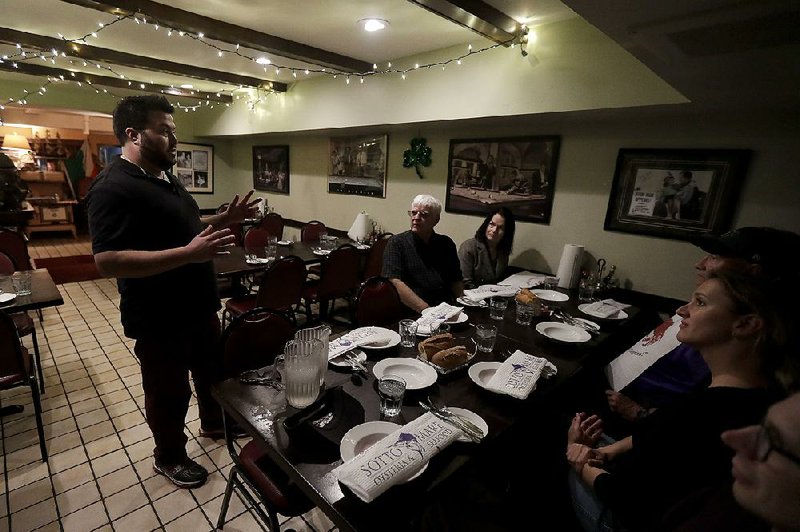 Avital Food Tours culinary guide Philip Hall (left) speaks to a group taking the tour recently at Sotto Mare restaurant in San Francisco. While inflation in the U.S. has been subdued in recent years, many small businesses have recently begun seeing rising costs, especially for labor and energy.  