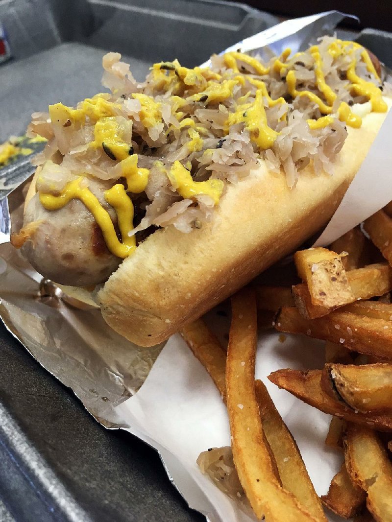 Fassler Hall’s Bratwurst comes topped with ample kraut and ribbons of spicy German mustard, plus a side order of the house Duck Fat Fries. 