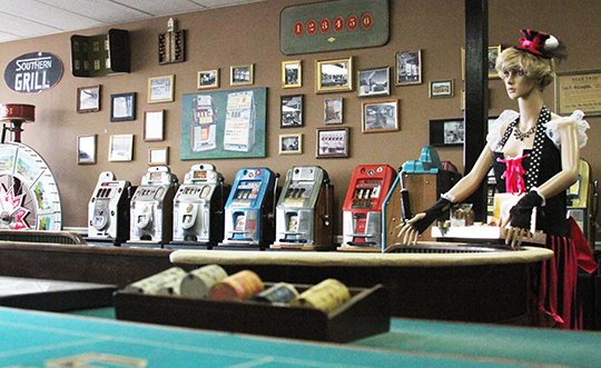 The Sentinel-Record/Rebekah Hedges MUSEUM: A wax figurine of a cigarette girl leans over a card table in the History of Hot Springs Gambling Museum. The museum holds more than 10 card tables and is home to 80 refurbished slot machines.