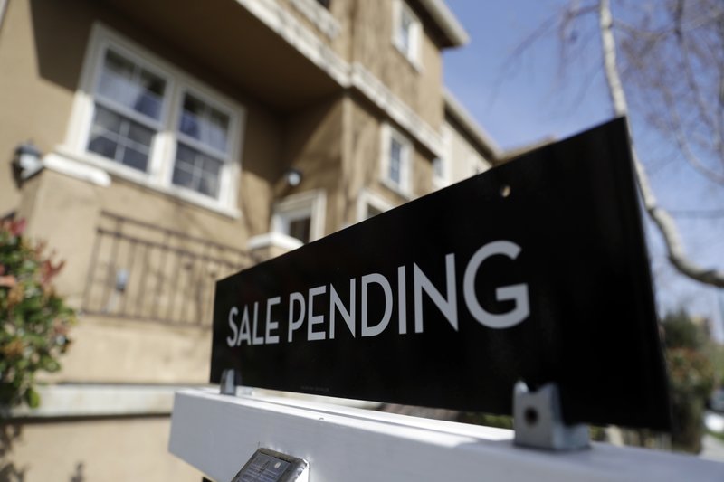 FILE- In this March 6, 2018, photo a sign advertises the pending sale of a home in San Jose, Calif. (AP Photo/Marcio Jose Sanchez, File)