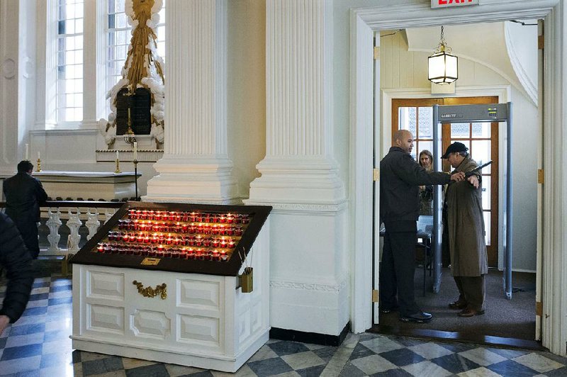 A security guard checks a visitor at the entrance to St. Paul’s Chapel in New York. 