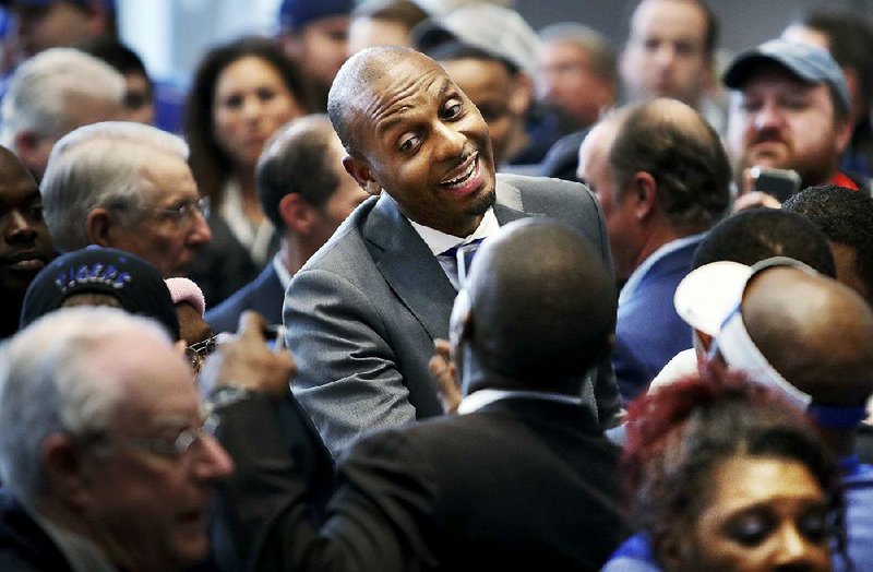 Fans gather around new Memphis men’s basketball Coach Anfernee “Penny” Hardaway during a news conference announcing his hiring March 20 at the Laurie-Walton Family Basketball Center in Memphis.  