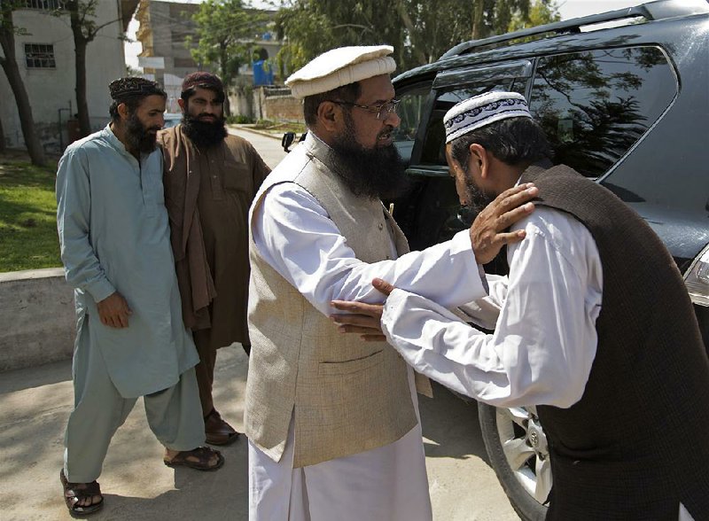 Pakistani militant leader Rehman Khalil (second from right) greets visitors at his compound in Islamabad on March 22.