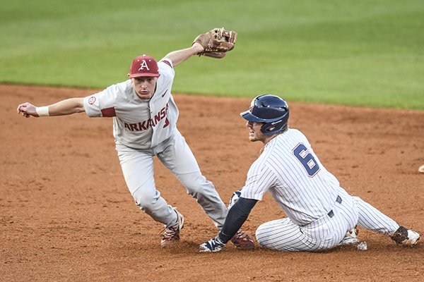 Arkansas' Jax Biggers (9) tags out Mississippi's Thomas Dillard (6) on a steal attempt during an NCAA college baseball game in Oxford, Miss. on Friday, March 30, 2018. (Bruce Newman/Oxford Eagle via AP)

