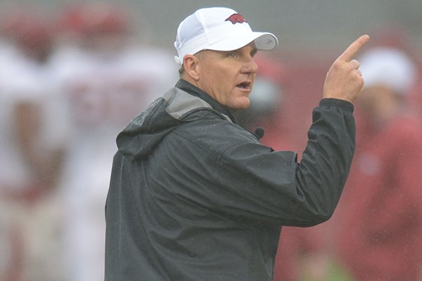 Arkansas coach Chad Morris speaks with players Wednesday, March 28, 2018, during practice at the university's practice facility on campus in Fayetteville. 