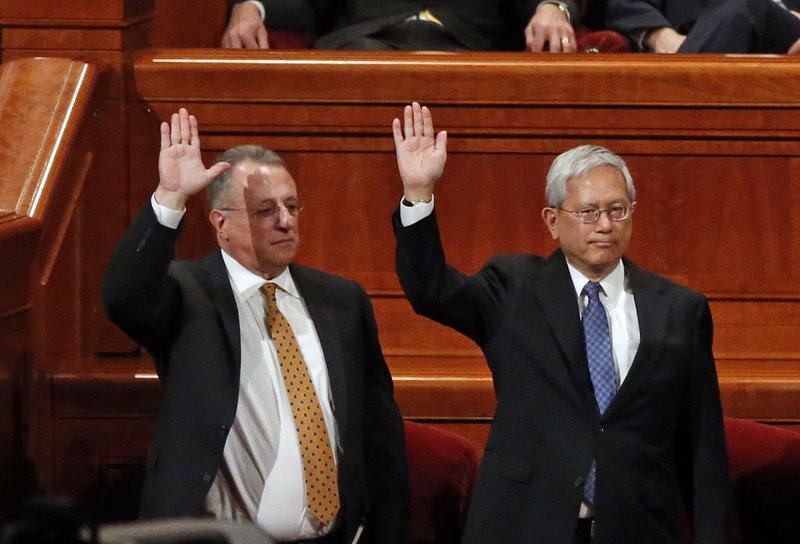 Ulisses Soares, left, of Brazil and Gerrit W. Gong, who is Chinese-American, join a panel called the Quorum of the Twelve Apostles at the start of a twice-annual conference of The Church of Jesus Christ of Latter-day Saints Saturday, March 31, 2018, in Salt Lake City. At the church conference this weekend in Salt Lake City, The Mormon church has made history and injected diversity into a top leadership panel by selecting the first-ever Latin American apostle and the first-ever apostle of Asian ancestry. 