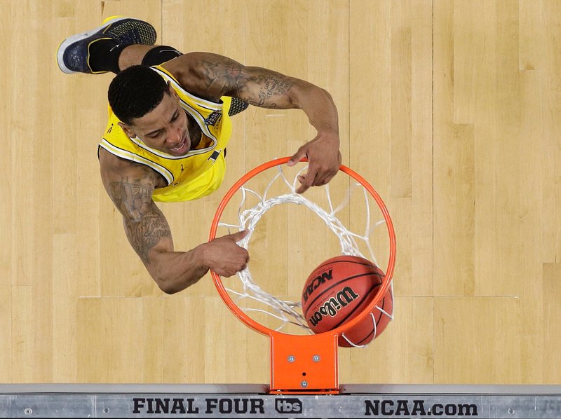 Michigan's Charles Matthews (1) dunks during the second half in the semifinals of the Final Four NCAA college basketball tournament against Loyola-Chicago, Saturday, March 31, 2018, in San Antonio. (AP Photo/David J. Phillip)

