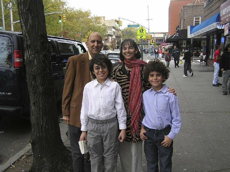 Lenore Skenazy and her husband, Joe, pose in 2008 with her sons Izzy (right), 10, and Morry, 12, on a street in New York. Her chronicle of her son’s independent journey through the city was the start of a modern movement.