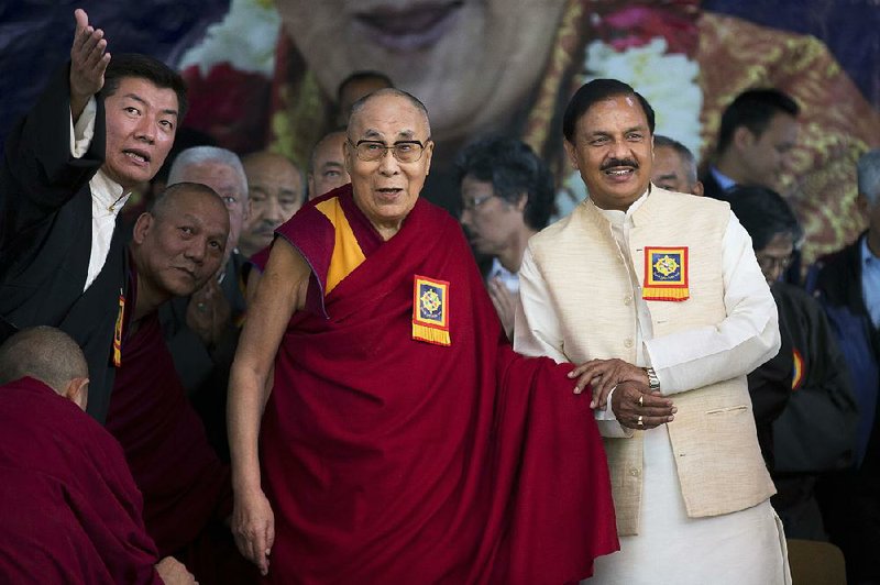 The Dalai Lama is flanked Saturday by Lobsang Sangay, prime minister of the self-declared Tibetan government-in-exile, (left) and India’s Minister for Culture and Tourism Mahesh Sharma at an event in Dharmsala, India, marking the 60th year of the Dalai Lama’s exile in India.

