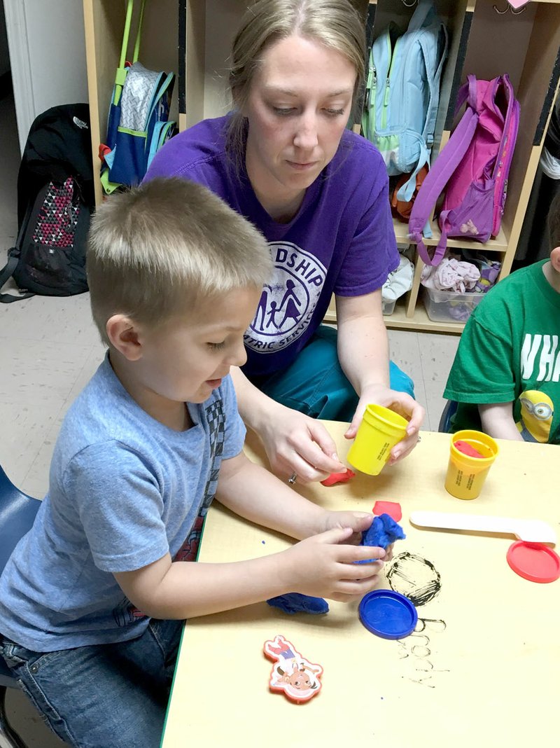 Photo submitted Friendship Pediatric Services student Brody Calcott plays with teacher Sarah Buck. Calcott is one of the students who will be impacted by the new &quot;one-therapy&quot; rule.