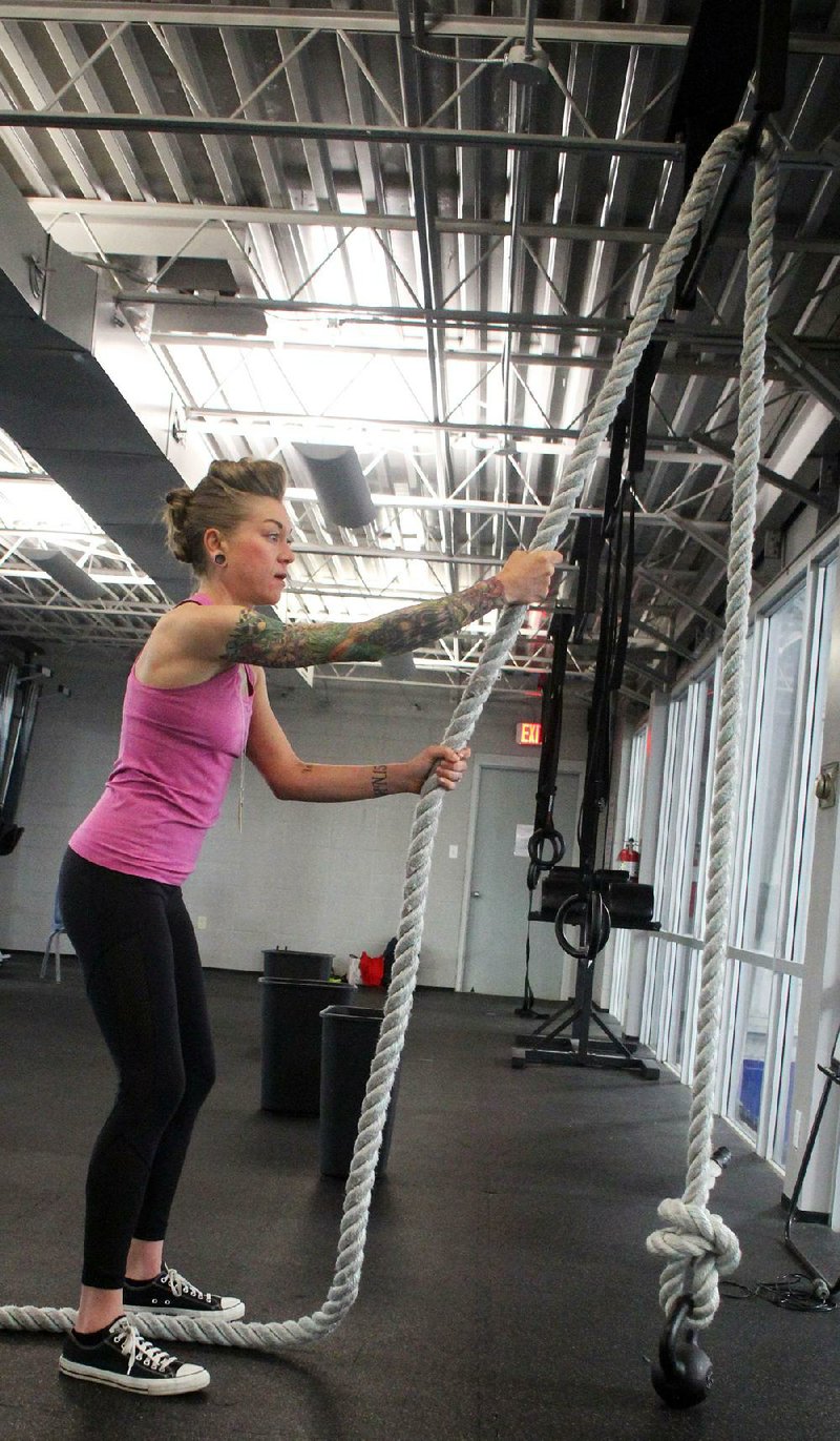 Fitness instructor Lindsay Petruk does step 1 of the Kettlebell Rope Pull exercise