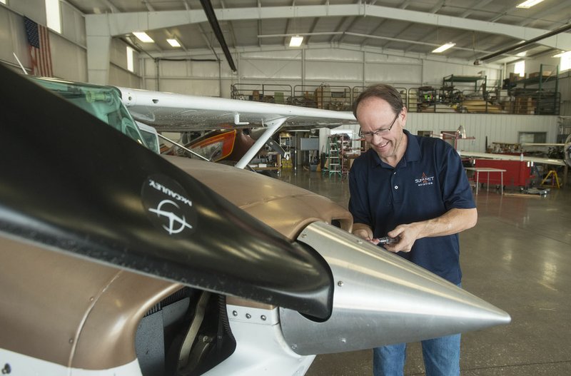 David Westphal, a mechanic with Summit Aviation, performs routine maintenance on a Cessna 172 March 23 in a hangar at Bentonville Municipal Airport.