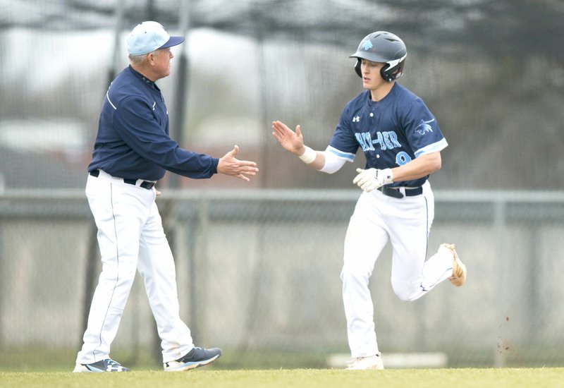 Springdale Har-Ber’s Lucas McCain (9) is congratulated by his coach as he rounds third base after hitting a home run Monday at the Tiger Athletic Complex in Bentonville.