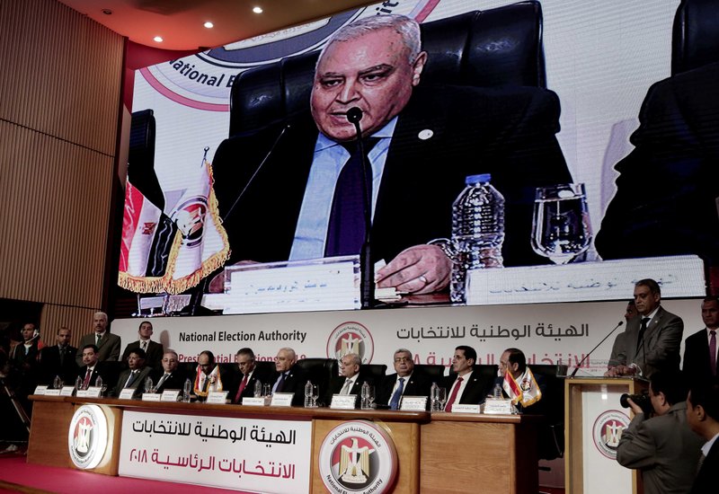 Lasheen Ibrahim, the head of Egypt's's election commission, seen on screen, announces the presidential election results during a press conference in Cairo, Monday, April 2, 2018. Egypt's election commission says President Abdel-Fattah el-Sissi has won a second, four-year term with 97 percent of the vote in last week's election, with turnout of 41.5 percent. (AP Photo/Nariman El-Mofty)