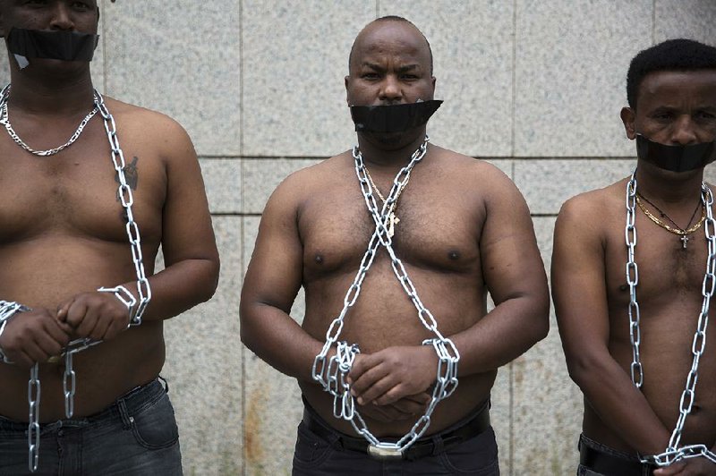 African migrants in Tel Aviv, Israel, wear chains to protest the government’s abrupt reversal of a plan to settle thousands of migrants in Israel and in Western countries.  
