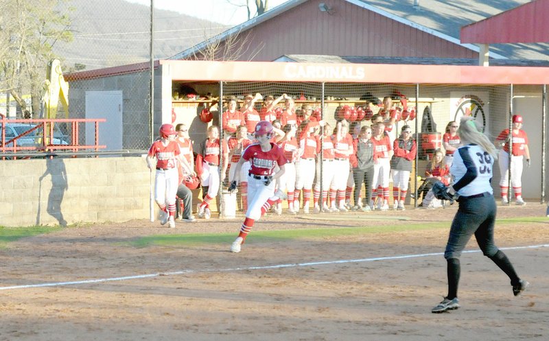 MARK HUMPHREY ENTERPRISE-LEADER Farmington sophomore Kally Stout appears to be racing against the silhouette of the on-deck batter as she rounds third and races for home. The Lady Cardinals routed Siloam Springs, 15-0, on Monday, March 5, at home.