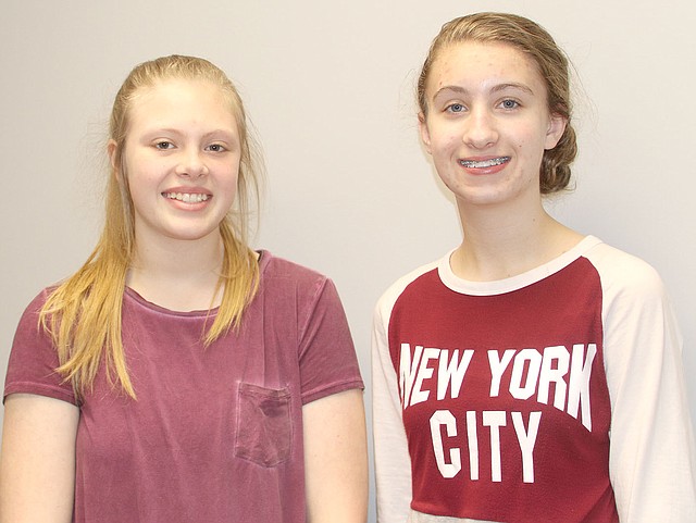 LYNN KUTTER ENTERPRISE-LEADER Carli Huffaker, left, and Madelyn Campbell, both seventh-graders in the EAST program at Lynch Middle School, have been creating logos for local businesses in town as part of a service project for their class.