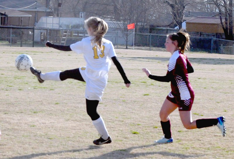 MARK HUMPHREY ENTERPRISE-LEADER Prairie Grove senior Stacey Johnson kicks the ball away during a girls soccer match held Monday, March 12, at Prairie Grove. The Lady Tigers and Gentry played to a scoreless tie.