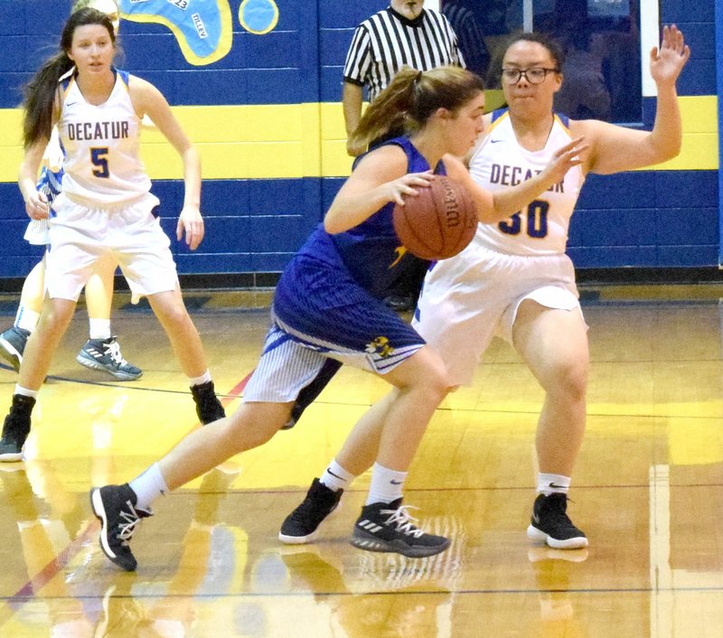 Westside Eagle Observer/MIKE ECKELS Airbus Dungsungnoen (right) cuts off a Lady Yellow Jacket player's attempt to drive towards the basket during the Dec. 5, 2017 Decatur-Kingston basketball contest at Peterson Gym in Decatur. Dungsungnoen never played basketball before coming to Decatur from Thailand. Eventually she became one of the Lady Bulldogs' leading defensive players.