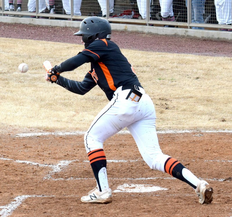 Westside Eagle Observer/MIKE ECKELS Gravette's Brady Moorman tries for a bunt which resulted in a base hit for the Lions during the Gravette-Pea Ridge baseball game at Lions Baseball Field in Gravette March 29. In spite of the Lions' best efforts, the Blackhawks took the conference victory, 12-4.